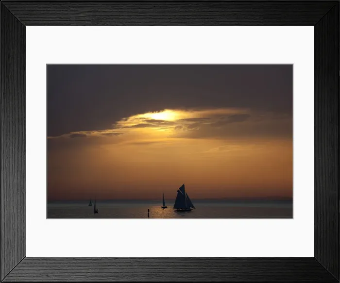 Framed Print : Yachts are silhouetted as sun sets over Lake Constance in Bregenz