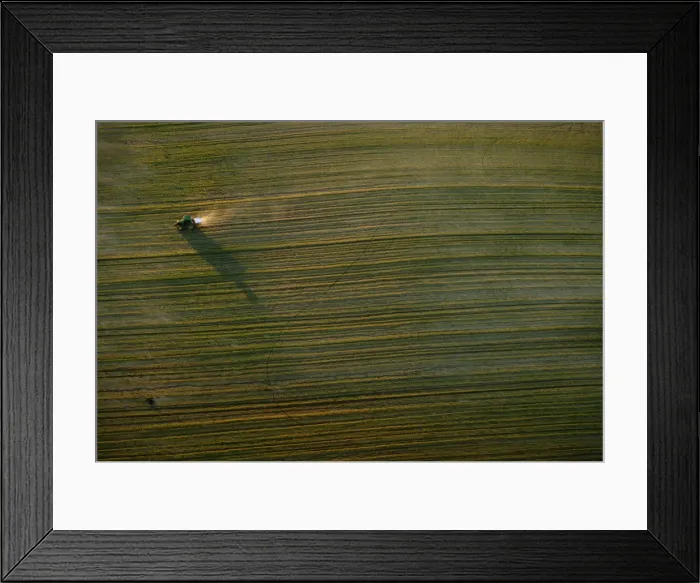 Framed Print : A tractor travels in a field near Donana Natural Reserve, southwest Spain