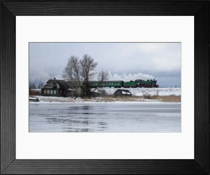 Framed Print : A steam train passes by along a dam outside Ostashkov Framed Print : A steam train passes by along a dam outside Ostashkov