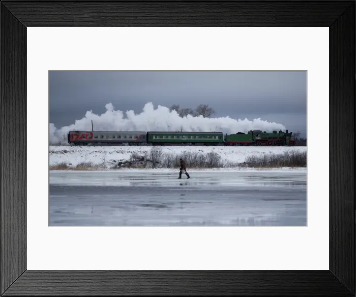 Framed Print : A steam train passes by along a dam outside Ostashkov Framed Print : A steam train passes by along a dam outside Ostashkov