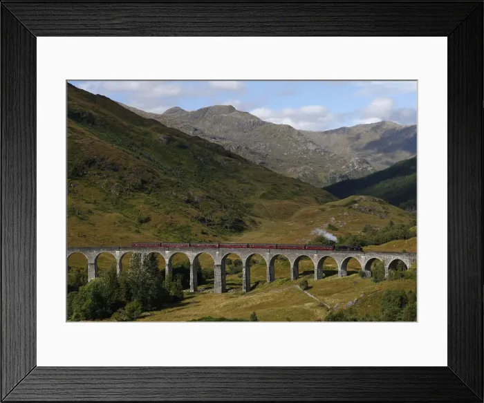 Framed Print : The Jacobite steam train crosses the Glenfinnan Viaduct in Scotland
