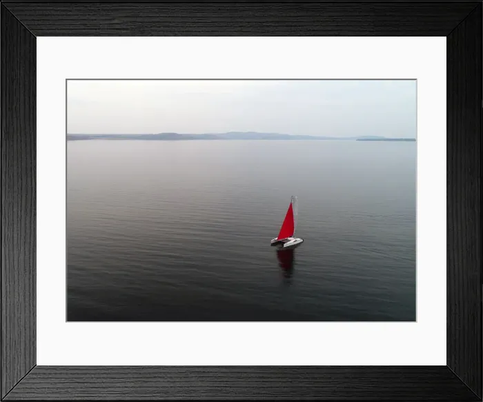 Framed Print : Aerial view shows a couple traveling on a sailing catamaran along the Yenisei River Framed Print : Aerial view shows a couple traveling on a sailing catamaran along the Yenisei River