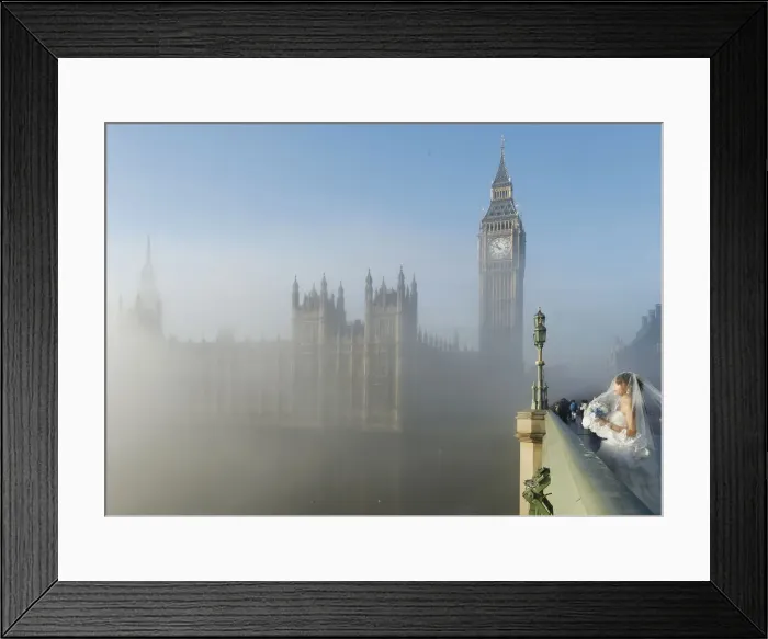 Framed Print : A bride poses for a photograph on Westminster Bridge as the fog clears in central London Framed Print : A bride poses for a photograph on Westminster Bridge as the fog clears in central London