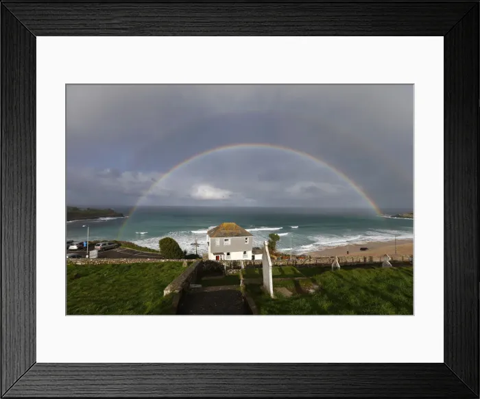 Framed Print : A rainbow forms as a squall moves towards Porthmeor Beach in St Ives in Cornwall Framed Print : A rainbow forms as a squall moves towards Porthmeor Beach in St Ives in Cornwall