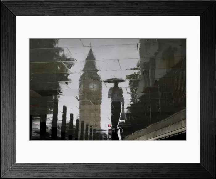 Framed Print : A man is reflected next to Big Ben on a wet pavement during a rainy day in central London Framed Print : A man is reflected next to Big Ben on a wet pavement during a rainy day in central London