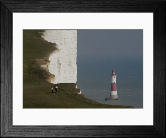 Framed Print : A couple walk along the Seven Sisters cliffs close to the Beachy Head lighthouse near Eastbourne Framed Print : A couple walk along the Seven Sisters cliffs close to the Beachy Head lighthouse near Eastbourne