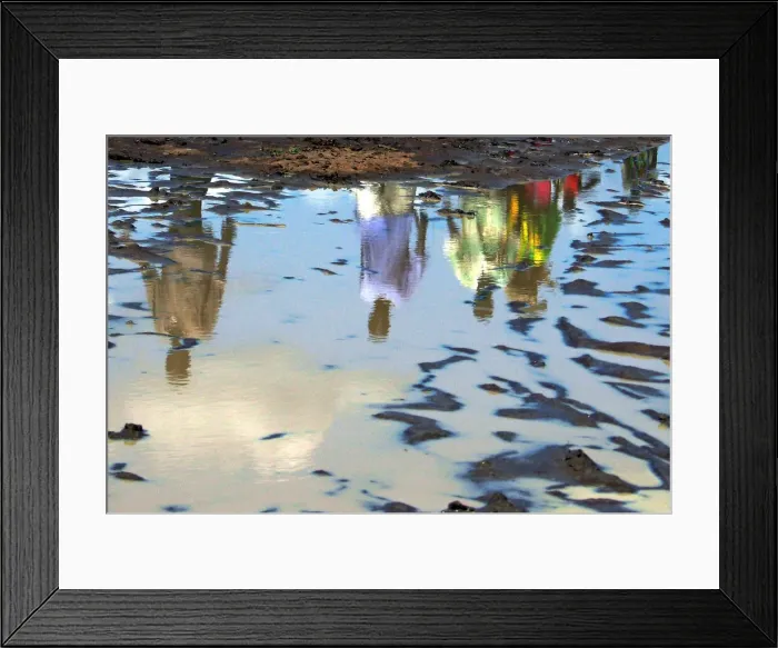 Framed Print : Sudanese are reflected in a pool of rain water in southern Sudan