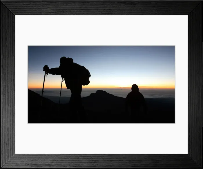 Framed Print : Climbers walk up the steep gravel and scree slope leading to the summit of Tanzania s