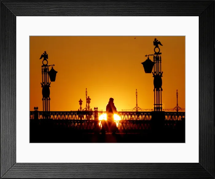 Framed Print : A person walks across a bridge in central St Petersburg