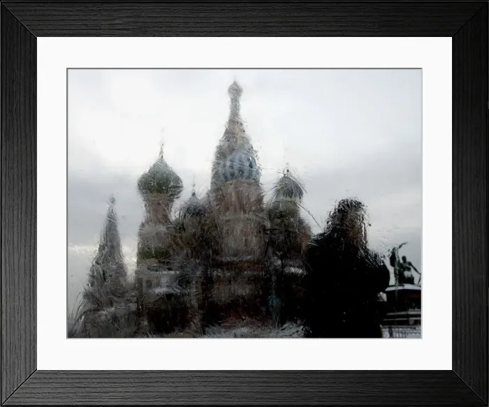 Framed Print : A man is seen through an iced window walking past St Framed Print : A man is seen through an iced window walking past St