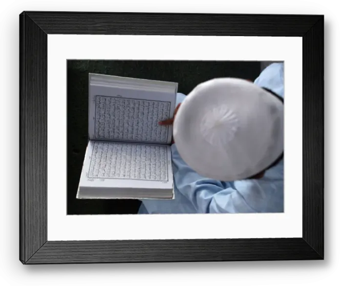 Framed Print : A boy reads the Koran in Mathura