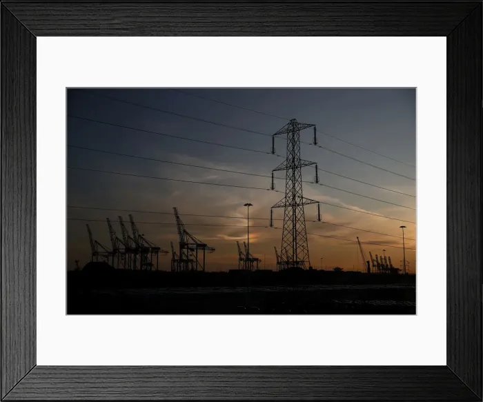 Framed Print : The sun sets behind cranes at the ABP port in Southampton Framed Print : The sun sets behind cranes at the ABP port in Southampton