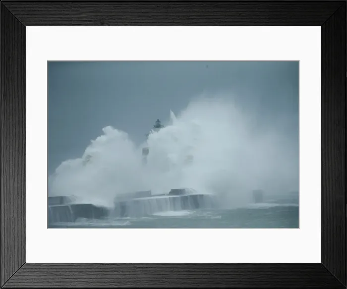 Framed Print : Waves crash against a lighthouse during a windy day in Boulogne-sur-Mer