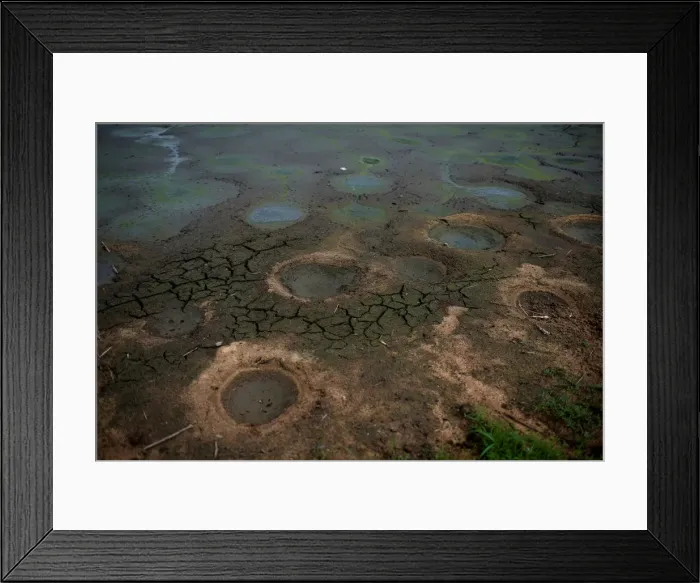Framed Print : A dry pond is pictured in a village of Menhai county Framed Print : A dry pond is pictured in a village of Menhai county