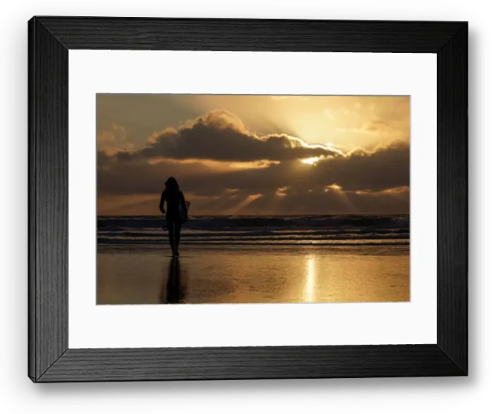 Framed Print : A female surfer walks out into the waves at Cardiff State Beach in Encinitas, California