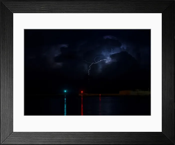 Framed Print : A lightning storm is seen beyond the entrance to Vallettas Grand Harbour Framed Print : A lightning storm is seen beyond the entrance to Vallettas Grand Harbour