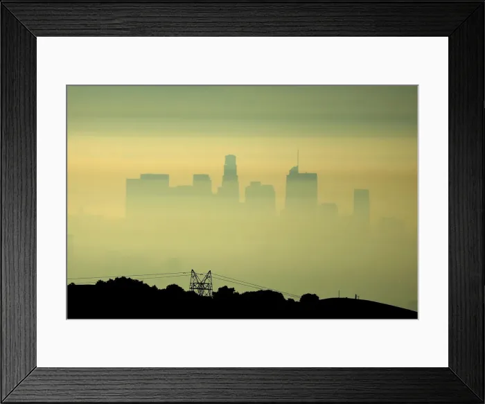 Framed Print : Downtown Los Angeles is seen behind an electricity pylon through the morning marine layer Framed Print : Downtown Los Angeles is seen behind an electricity pylon through the morning marine layer