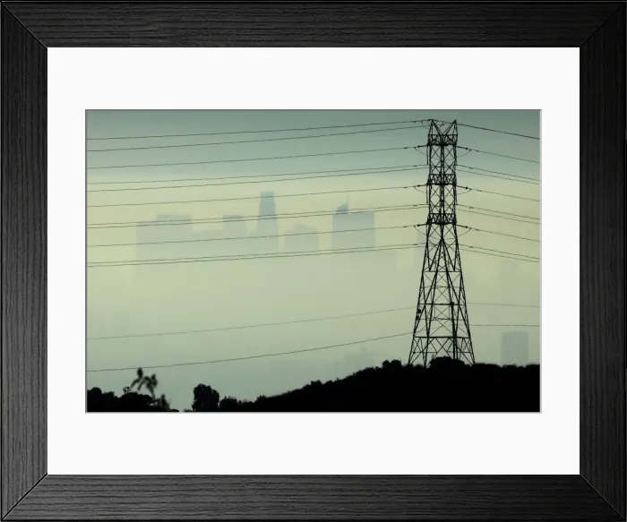 Framed Print : Downtown Los Angeles is seen behind an electricity pylon through the morning marine layer Framed Print : Downtown Los Angeles is seen behind an electricity pylon through the morning marine layer