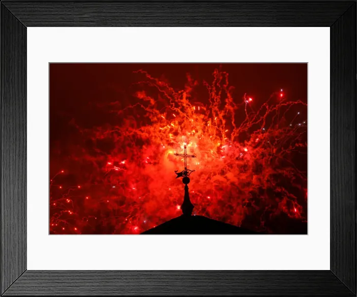 Framed Print : A cross of the Basilica of the Agustinas Recoletas is seen as fireworks explode over