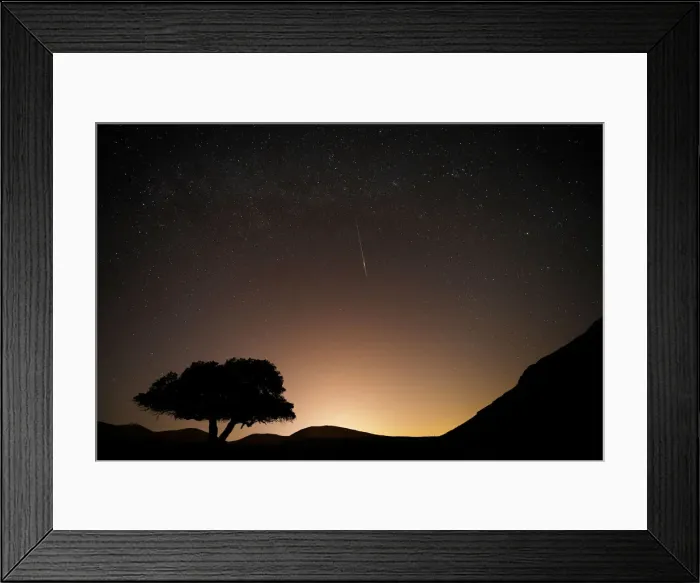 Framed Print : A long exposure shows a meteor streaking across the sky in the early morning during