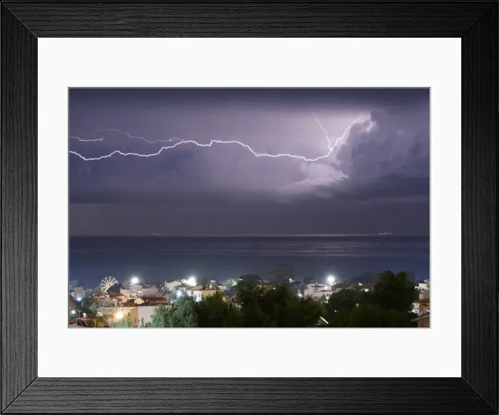 Framed Print : Lightnings strike in the sea off the shore of Artemida