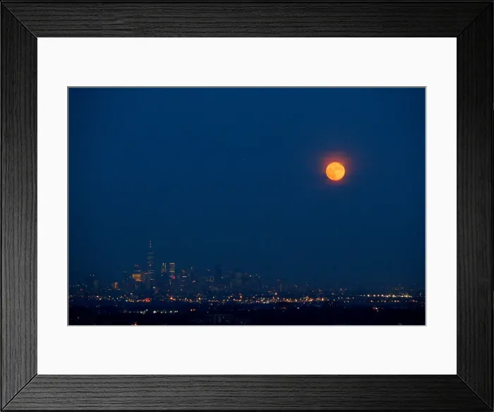 Framed Print : The full moon rises over the skyline of New York and One World Trade Center as seen Framed Print : The full moon rises over the skyline of New York and One World Trade Center as seen