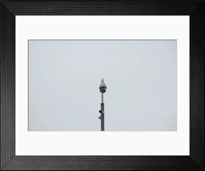 Framed Print : A surveillance camera is seen in the Kings Cross area in London Framed Print : A surveillance camera is seen in the Kings Cross area in London