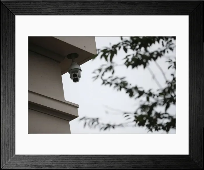 Framed Print : A surveillance camera is seen in the Kings Cross area in London Framed Print : A surveillance camera is seen in the Kings Cross area in London