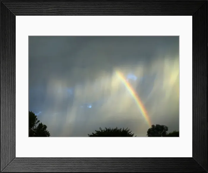 Framed Print : A summer rainbow breaks through an isolated and quickly moving thunderstorm as it passes Framed Print : A summer rainbow breaks through an isolated and quickly moving thunderstorm as it passes