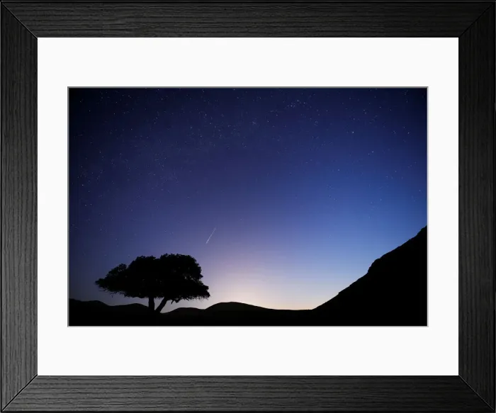 Framed Print : A long exposure shows a meteor streaking across the sky in the early morning during Framed Print : A long exposure shows a meteor streaking across the sky in the early morning during