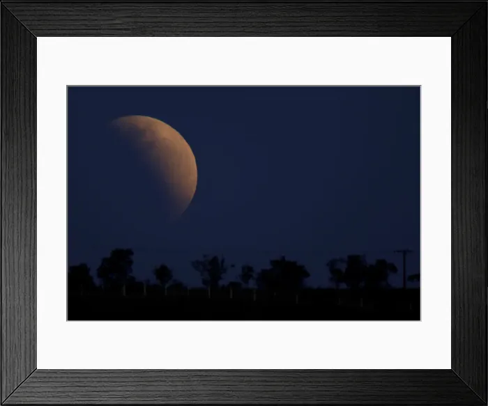 Framed Print : A moon is seen during a partial lunar eclipse in Brasilia