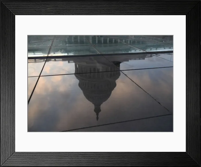 Framed Print : The U. S. Capitol building is seen in a reflection on Capitol Hill in Washington