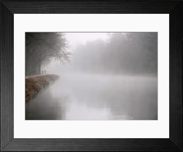 Framed Print : People walk along the Isar river covered in fog in Munich Framed Print : People walk along the Isar river covered in fog in Munich
