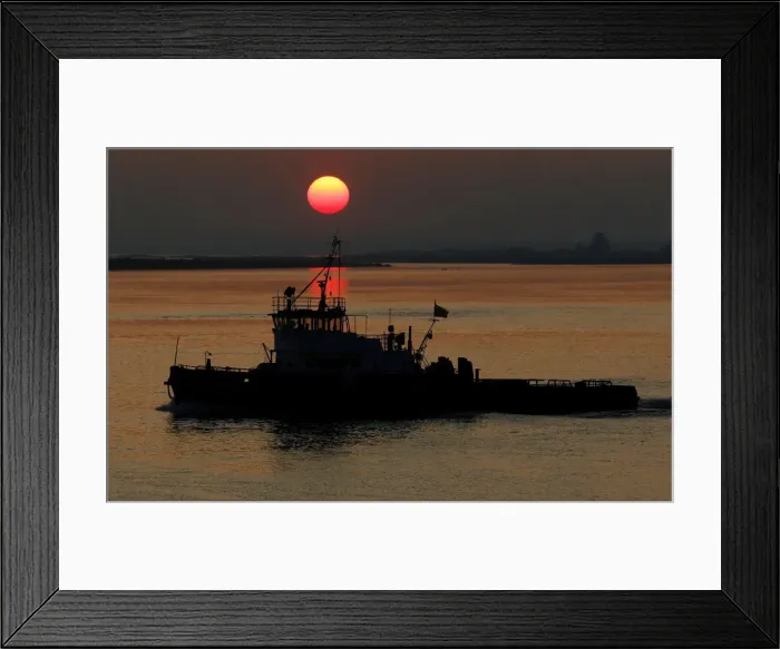 Framed Print : A boat sails as the sun sets over the place of a confluence of Angara and Yenisei rivers