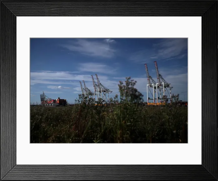 Framed Print : Shipping containers stacked on a cargo ship are seen in the dock at the ABP port in Framed Print : Shipping containers stacked on a cargo ship are seen in the dock at the ABP port in