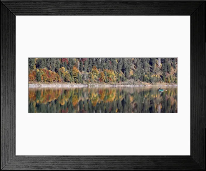Framed Print : A fisherman rows his boat during a sunny autumn day at the Sylvenstein barrier lake Framed Print : A fisherman rows his boat during a sunny autumn day at the Sylvenstein barrier lake