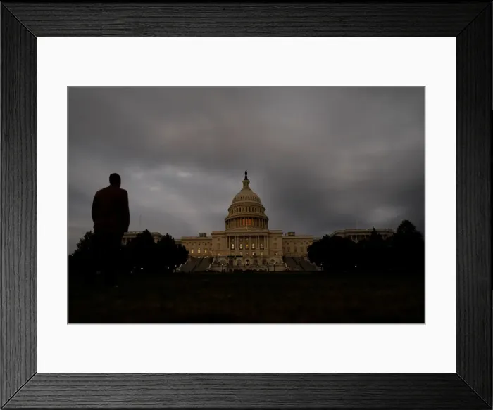 Framed Print : A man looks at the U. S. Capitol Building in Washington Framed Print : A man looks at the U. S. Capitol Building in Washington