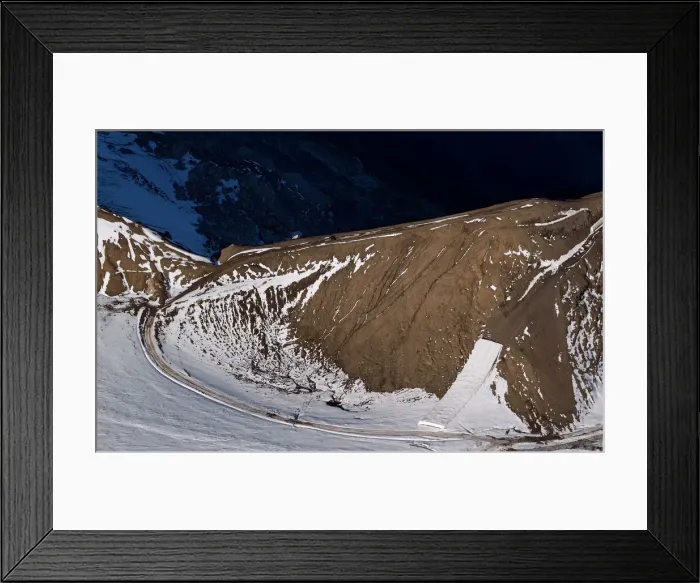 Framed Print : A patch of snow is covered for tourists to use with slides later in the season on