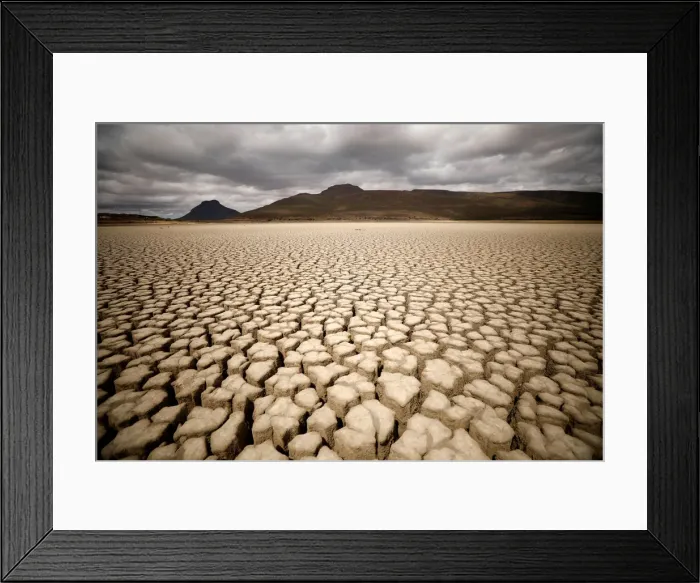 Framed Print : Clouds gather but produce no rain as cracks are seen in the dried up municipal dam in Framed Print : Clouds gather but produce no rain as cracks are seen in the dried up municipal dam in
