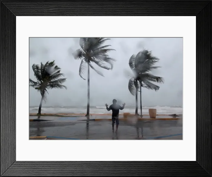 Framed Print : A man reacts in the winds and rain in Luquillo as Hurricane Irma slammed across islands