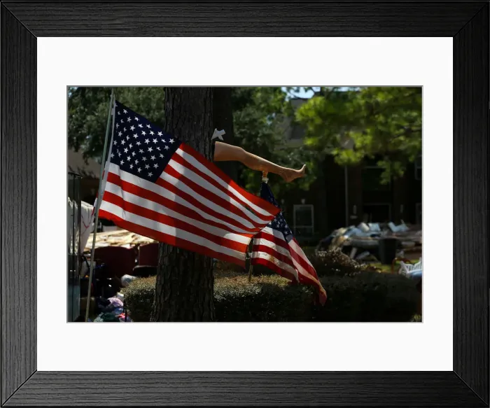 Framed Print : The leg of a mannequin is nailed to a tree outside a flooded damaged home following Framed Print : The leg of a mannequin is nailed to a tree outside a flooded damaged home following