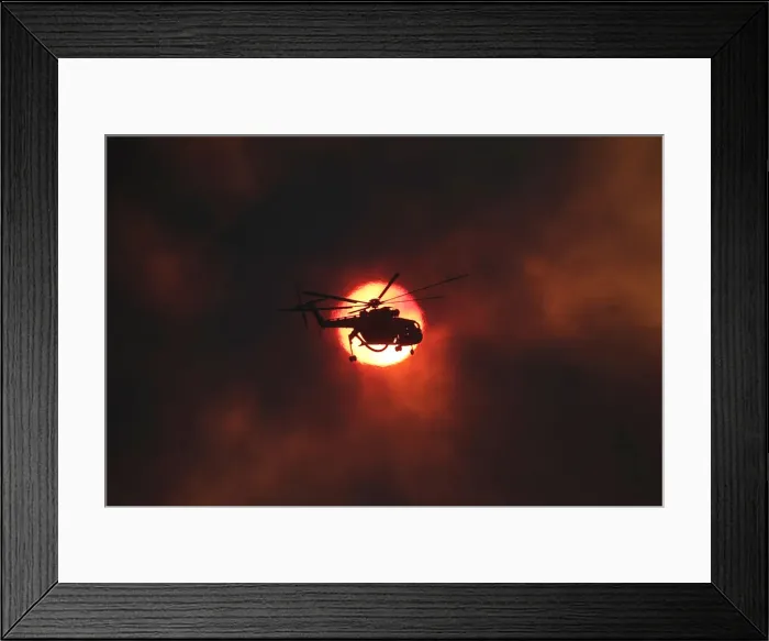 Framed Print : A firefighting helicopter flies in front of the setting sun as a wildfire burns near Framed Print : A firefighting helicopter flies in front of the setting sun as a wildfire burns near