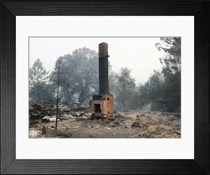 Framed Print : A chimney stands amidst remains of a home destroyed by the Detwiler fire in Mariposa