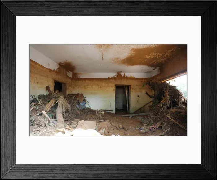 Framed Print : Flood level marks are seen on the wall inside a room filled with muds Framed Print : Flood level marks are seen on the wall inside a room filled with muds