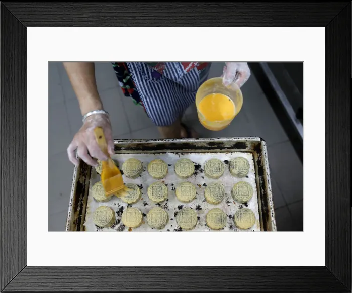 Framed Print : An employee makes mooncakes with anti-extradition bill slogans at Wah Yee Tang Bakery in Framed Print : An employee makes mooncakes with anti-extradition bill slogans at Wah Yee Tang Bakery in