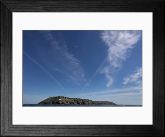Framed Print : Cirrus clouds and contrails are seen above the island of Lundy Framed Print : Cirrus clouds and contrails are seen above the island of Lundy