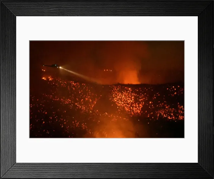 Framed Print : A helicopter flies above glowing embers as it makes a water drop run at the Old Fire