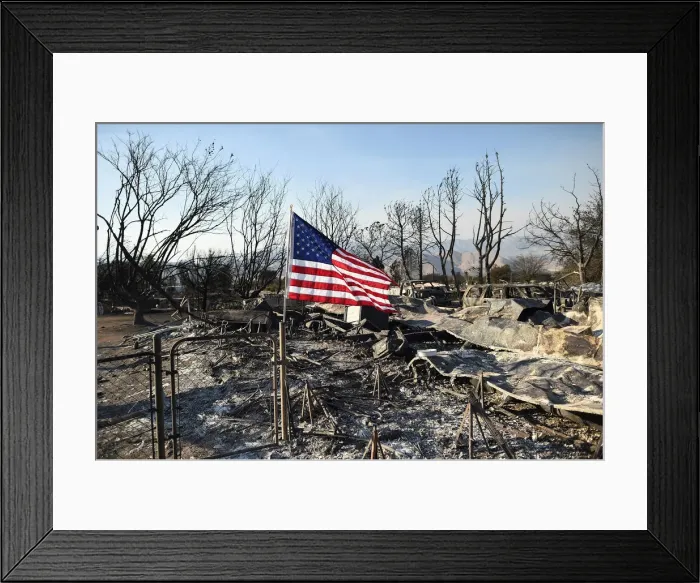 Framed Print : An American flag flies above wreckage at a residence leveled by the Erskine Fire in South