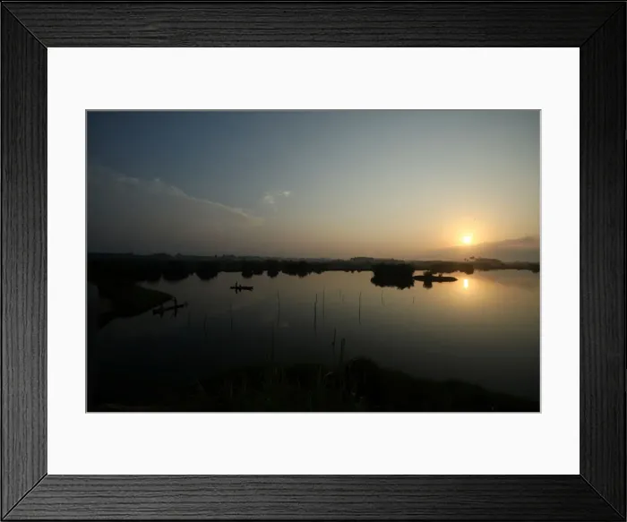 Framed Print : A canoe is seen on the lake by the road to the port of no return in the historic slave Framed Print : A canoe is seen on the lake by the road to the port of no return in the historic slave