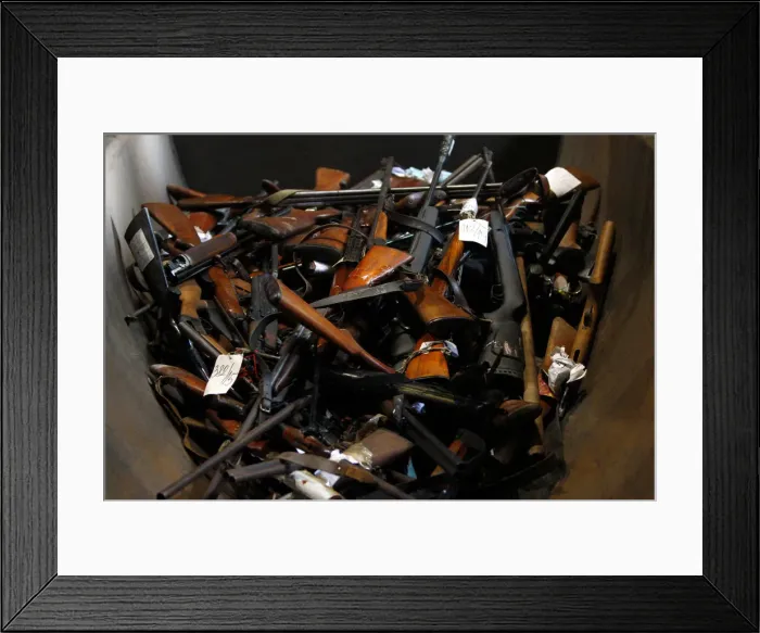 Framed Print : Weapons and drugs are displayed prior to their destruction in a melting nickel plant near